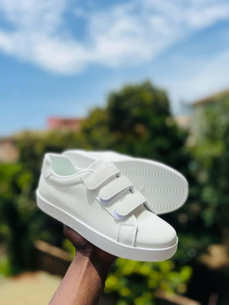 white sneakers feature a convenient three-strap hook-and-loop