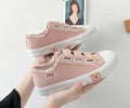 pink canvas sneakers feature a velcro strap closure