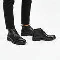 black leather ankle boots feature a cap-toe design and a thick