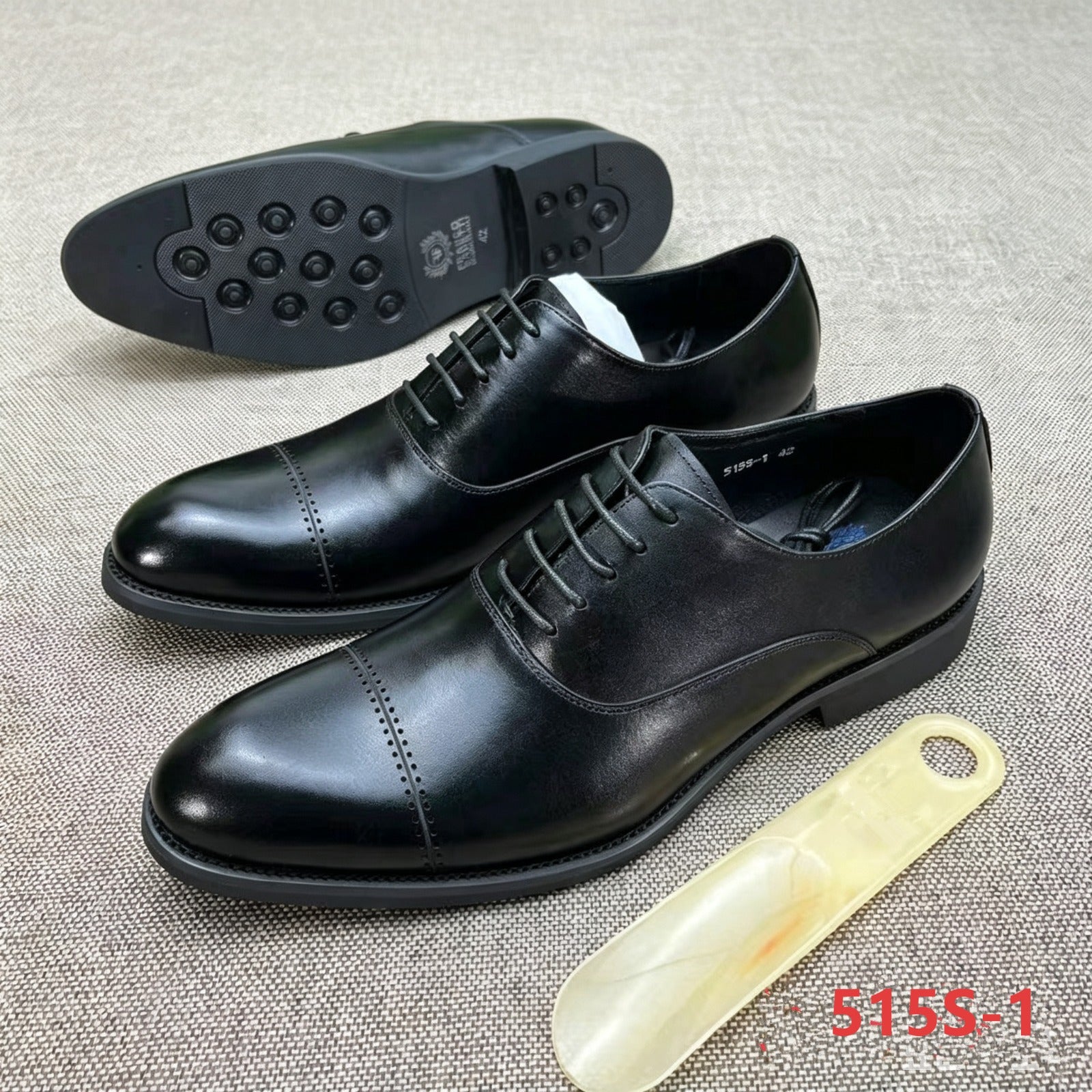 black leather cap-toe Oxford dress shoes