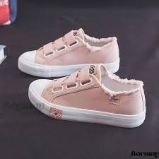 pink canvas sneakers feature a velcro strap closure