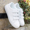 white sneakers feature a convenient three-strap hook-and-loop