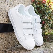white sneakers feature a convenient three-strap hook-and-loop