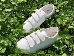 white sneakers feature a convenient three-strap hook-and-loop