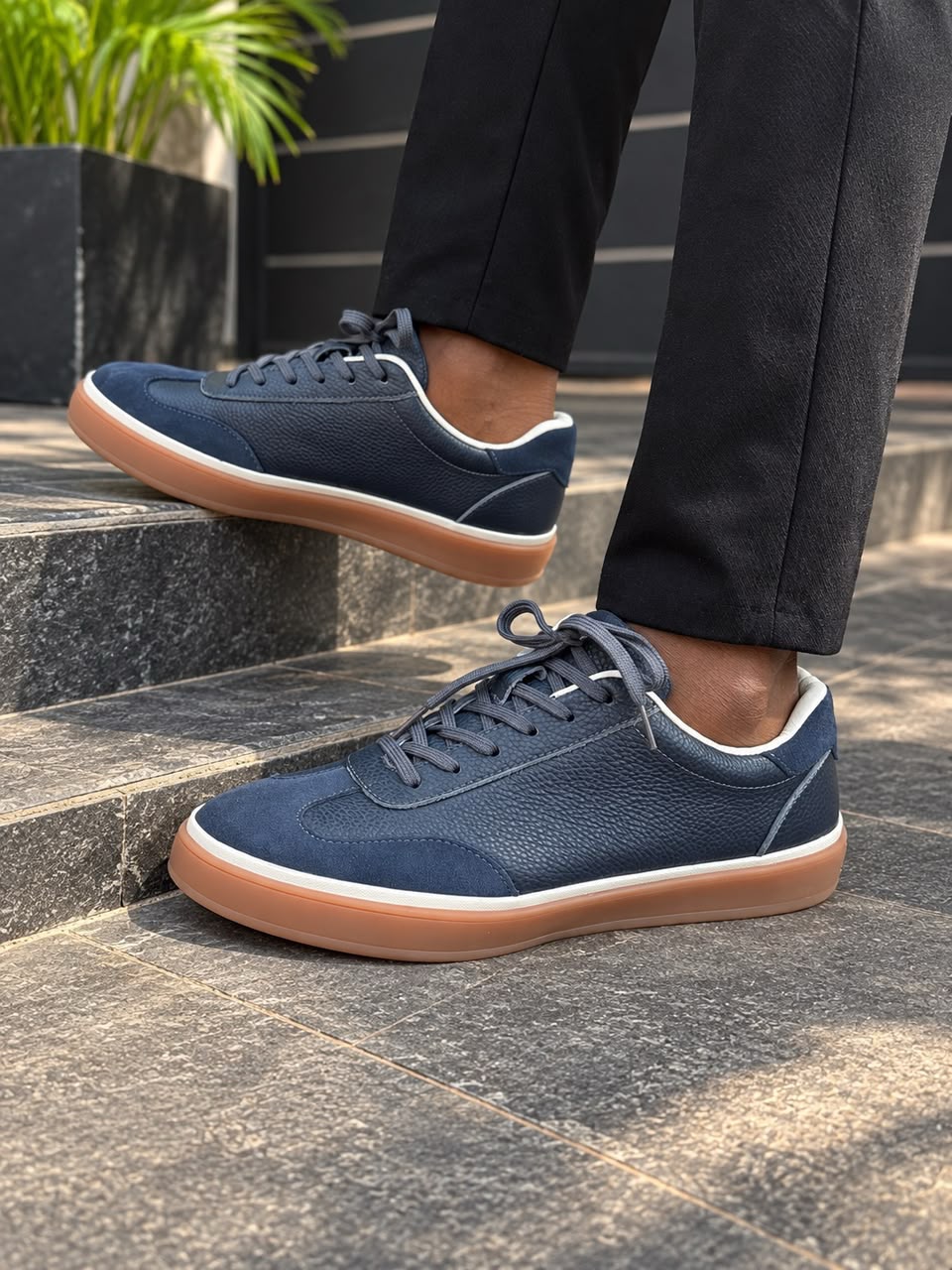 Dark blue or navy low-top casual leather and suede sneakers