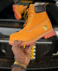 Yellow, lace-up ankle boot with a brown padded collar