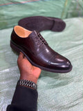 classic pair of black leather cap-toe Oxford dress shoes